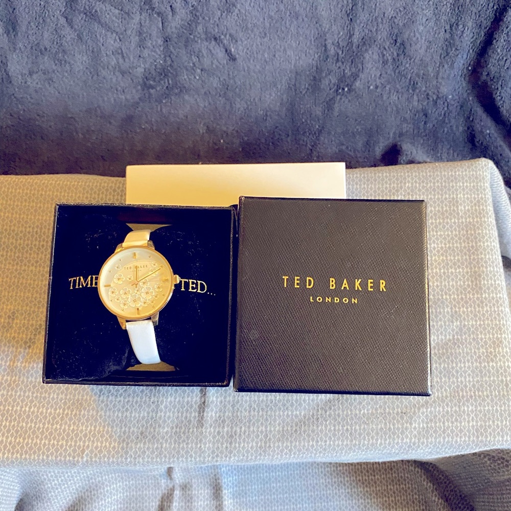 Ted Baker London watch; gold with white wrist band approx. 9”; champagne face